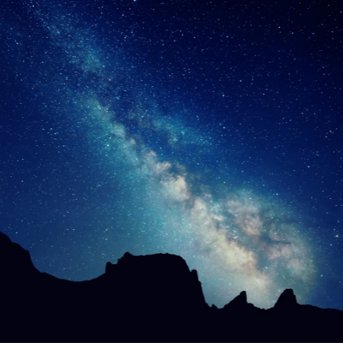 The Milky Way over a dark rock skyline